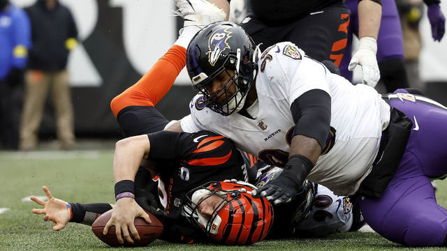 CINCINNATI, OH - JANUARY 08: Joe Burrow #9 of the Cincinnati Bengals is tackled by Travis Jones #98 of the Baltimore Ravens during the game at Paycor Stadium on January 8, 2023 in Cincinnati, Ohio.