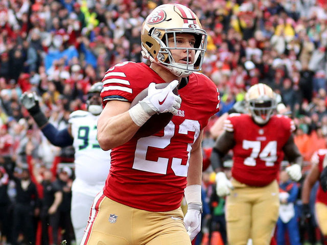 SANTA CLARA, CALIFORNIA - JANUARY 14: Christian McCaffrey #23 of the San Francisco 49ers celebrates after scoring a 3 yard touchdown against the Seattle Seahawks during the first quarter in the NFC Wild Card playoff game at Levi's Stadium on January 14, 2023 in Santa Clara, California.