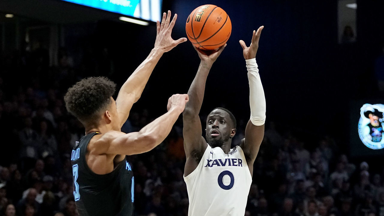 CINCINNATI, OHIO - JANUARY 15: Souley Boum #0 of the Xavier Musketeers attempts a shot while being guarded by Oso Ighodaro #13 of the Marquette Golden Eagles in the second half at the Cintas Center on January 15, 2023 in Cincinnati, Ohio.