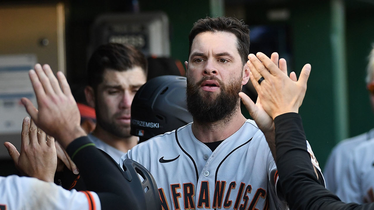 PITTSBURGH, PA - JUNE 18: Brandon Belt #9 of the San Francisco Giants high fives with Luis Gonzalez #51 in the dugout after coming around to score on a run scoring sacrifice fly ball by Mike Yastrzemski #5 in the sixth inning during the game against the Pittsburgh Pirates at PNC Park on June 18, 2022 in Pittsburgh, Pennsylvania.