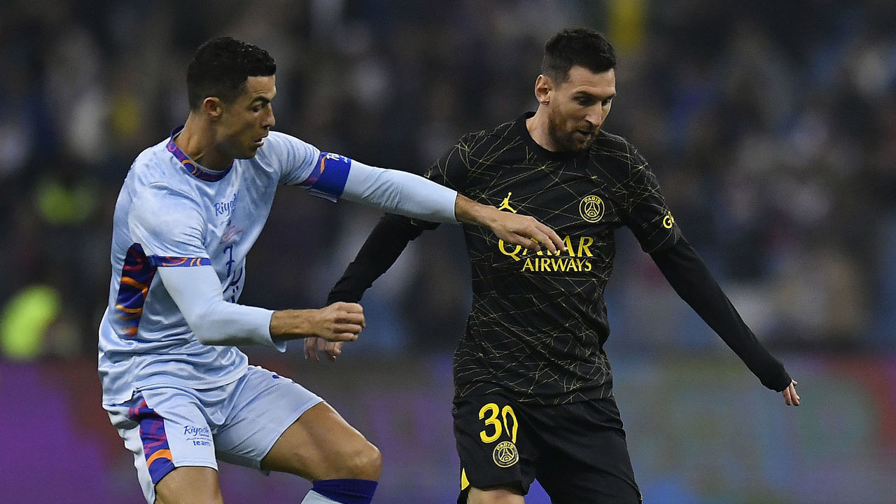 RIYADH, SAUDI ARABIA - JANUARY 19: Leo Messi of Paris Saint-Germain and Cristiano Ronaldo of Ruyadh XI fight for possession during the friendly match between Paris Saint-Germain and Riyadh XI at King Fahd International Stadium on January 19, 2023 in Riyadh, Saudi Arabia.