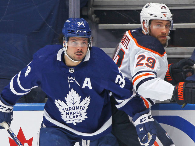 TORONTO, ON - JANUARY 5: Leon Draisaitl #29 of the Edmonton Oilers battles against Auston Matthews #34 of the Toronto Maple Leafs during an NHL game at Scotiabank Arena on January 5, 2022 in Toronto, Ontario, Canada.