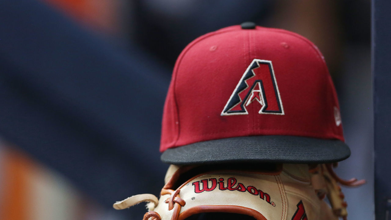 MILWAUKEE, WI - OCTOBER 05: An Arizona Diamondbacks hat and glove sit on the wall during a game between the Milwaukee Brewers and the Arizona Diamondbacks on October 5, 2022, at American Family Field, in Milwaukee, WI.
