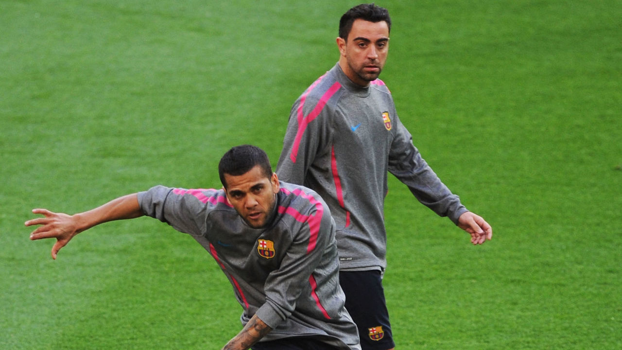 LONDON, ENGLAND - MAY 27: Daniel Alves of FC Barcelona (L) kicks the ball as teammate Xavi looks on during a Barcelona training session prior to the UEFA Champions League final versus Manchester United at Wembley Stadium on May 27, 2011 in London, England.
