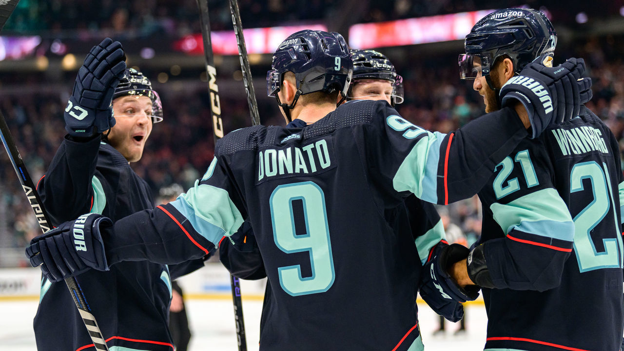 SEATTLE, WASHINGTON - JANUARY 19: Ryan Donato #9 celebrates his goal with Alex Wennberg #21, Will Borgen #3 and Jared McCann #19 of the Seattle Kraken during the first period of a game against the New Jersey Devils at Climate Pledge Arena on January 19, 2023 in Seattle, Washington.