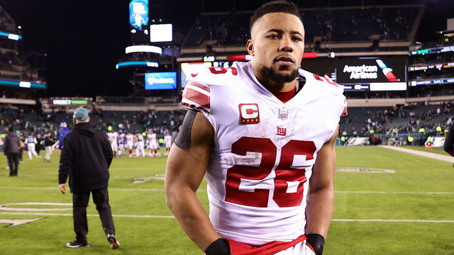 PHILADELPHIA, PENNSYLVANIA - JANUARY 21: Saquon Barkley #26 of the New York Giants walks off the field after losing to the Philadelphia Eagles 38-7 in the NFC Divisional Playoff game at Lincoln Financial Field on January 21, 2023 in Philadelphia, Pennsylvania.