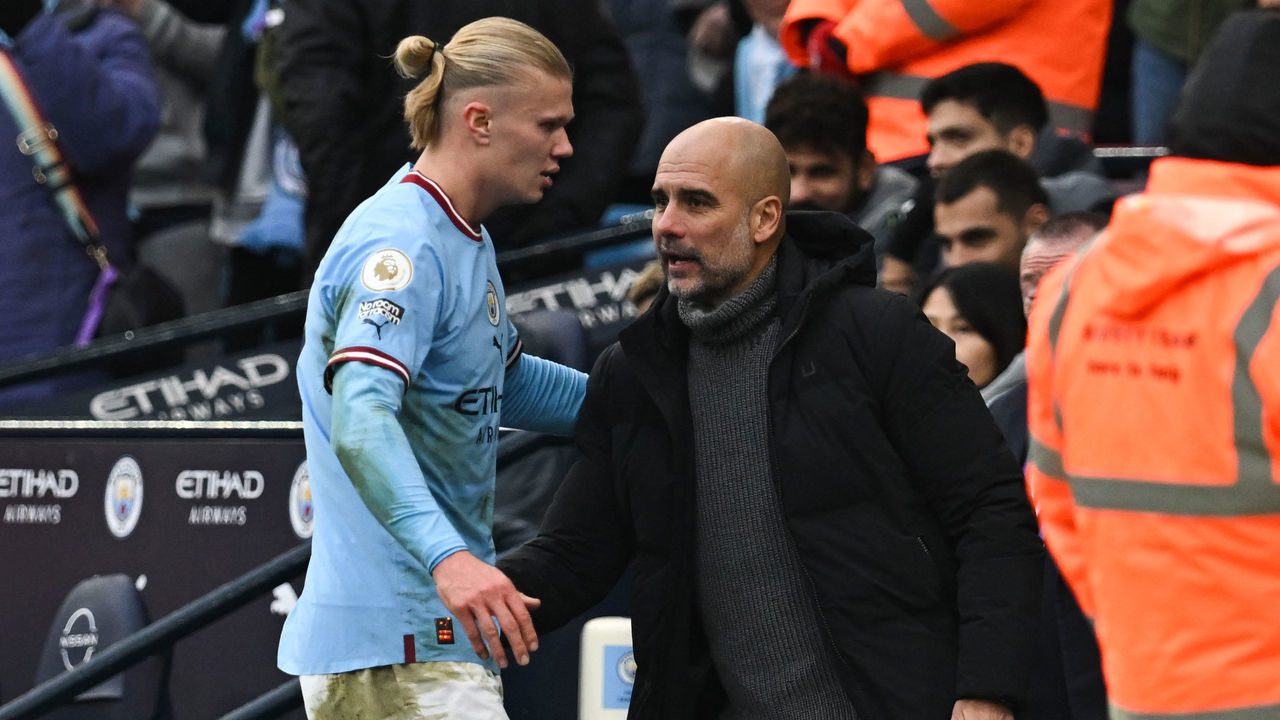 Manchester City's Norwegian striker Erling Haaland (L) is congratulated by Manchester City's Spanish manager Pep Guardiola as he leaves the pitch during the English Premier League football match between Manchester City and Wolverhampton Wanderers at the Etihad Stadium in Manchester, north west England, on January 22, 2023. - RESTRICTED TO EDITORIAL USE. No use with unauthorized audio, video, data, fixture lists, club/league logos or 'live' services. Online in-match use limited to 120 images. An additional 40 images may be used in extra time. No video emulation. Social media in-match use limited to 120 images. An additional 40 images may be used in extra time. No use in betting publications, games or single club/league/player publications.