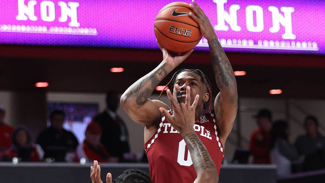 HOUSTON, TEXAS - JANUARY 22: Khalif Battle #0 of the Temple Owls shoots over Marcus Sasser #0 of the Houston Cougars during the first half at Fertitta Center on January 22, 2023 in Houston, Texas.