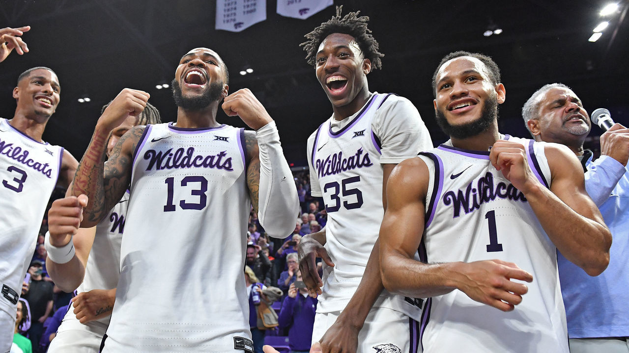 MANHATTAN, KS - JANUARY 17: Head coach Jerome Tang of the Kansas State Wildcats (R) celebrates with players Markquis Nowell #1, Nae'Qwan Tomlin #35, Desi Sills #13, and David N'Guessan #3 of the Kansas State Wildcats, after beating the Kansas Jayhawks in overtime 83-82 at Bramlage Coliseum on January 17, 2023 in Manhattan, Kansas.