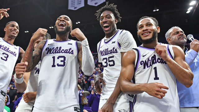 MANHATTAN, KS - JANUARY 17: Head coach Jerome Tang of the Kansas State Wildcats (R) celebrates with players Markquis Nowell #1, Nae'Qwan Tomlin #35, Desi Sills #13, and David N'Guessan #3 of the Kansas State Wildcats, after beating the Kansas Jayhawks in overtime 83-82 at Bramlage Coliseum on January 17, 2023 in Manhattan, Kansas.