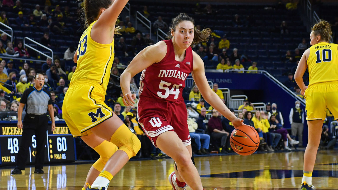 ANN ARBOR, MICHIGAN - JANUARY 23: Mackenzie Holmes #54 of the Indiana Hoosiers dribbles the ball against Emily Kiser #33 of the Michigan Wolverines during the second half of a women's college basketball game at Crisler Arena on January 23, 2023 in Ann Arbor, Michigan. The Indiana Hoosiers won the game 92-83 over the Michigan Wolverines.