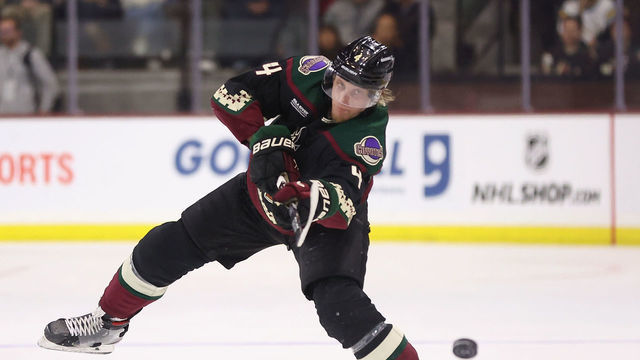 TEMPE, ARIZONA - JANUARY 10: Juuso Valimaki #4 of the Arizona Coyotes dumps the puck during the NHL game at Mullett Arena on January 10, 2023 in Tempe, Arizona. The Sharks defeated the Coyotes 4-2.