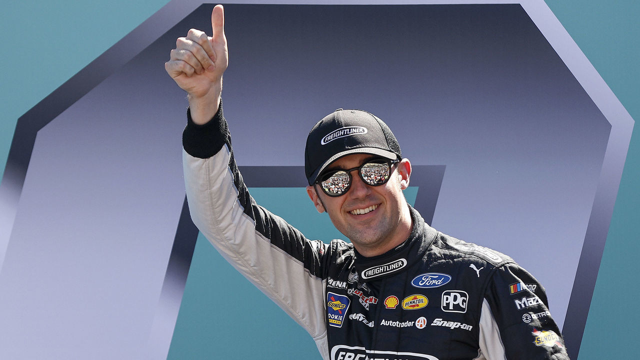 HOMESTEAD, FLORIDA - OCTOBER 23: Austin Cindric, driver of the #2 Freightliner Ford, gives a thumbs up to fans as he walks onstage during driver intros prior to the NASCAR Cup Series Dixie Vodka 400 at Homestead-Miami Speedway on October 23, 2022 in Homestead, Florida.