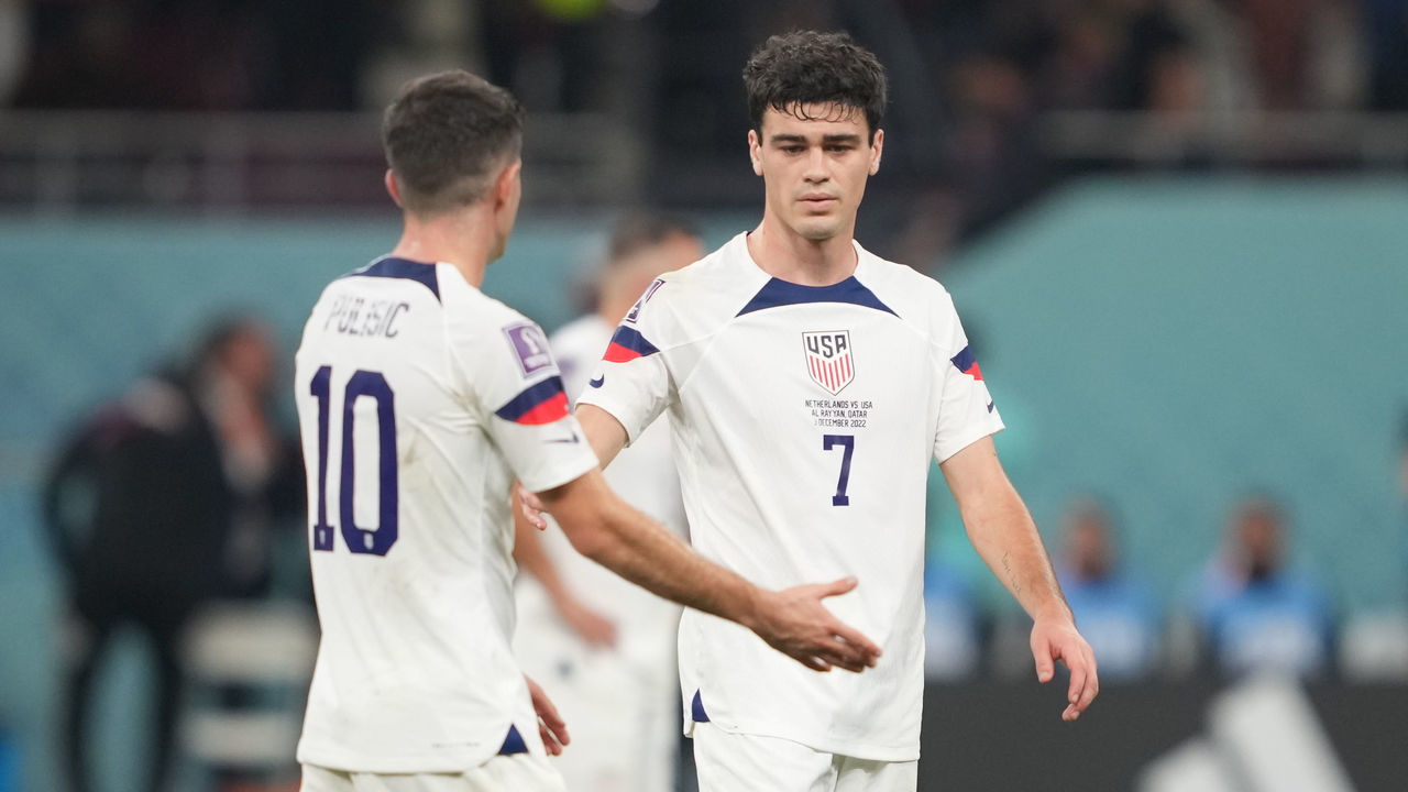 DOHA, QATAR - DECEMBER 3: Christian Pulisic #10 and Gio Reyna #7of the United States find solis with one another after their loss to the Netherlands after a FIFA World Cup Qatar 2022 Round of 16 match between Netherlands and USMNT at Khalifa International Stadium on December 3, 2022 in Doha, Qatar.