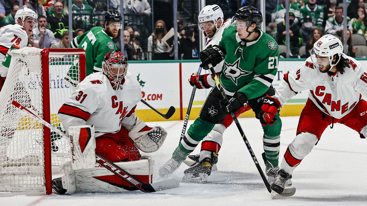 DALLAS, TX - NOVEMBER 30: Carolina Hurricanes goaltender Frederik Andersen (31) blocks a shot as Dallas Stars left wing Jason Robertson (21) and Carolina Hurricanes defenseman Jalen Chatfield (64) look for the puck during the game between the Dallas Stars and the Carolina Hurricanes on November 30, 2021 at the American Airlines Center in Dallas, Texas.
