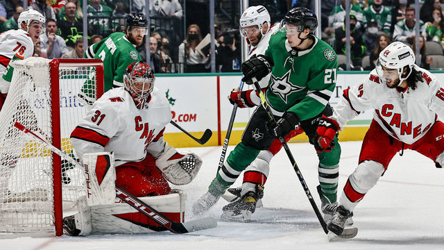 DALLAS, TX - NOVEMBER 30: Carolina Hurricanes goaltender Frederik Andersen (31) blocks a shot as Dallas Stars left wing Jason Robertson (21) and Carolina Hurricanes defenseman Jalen Chatfield (64) look for the puck during the game between the Dallas Stars and the Carolina Hurricanes on November 30, 2021 at the American Airlines Center in Dallas, Texas.