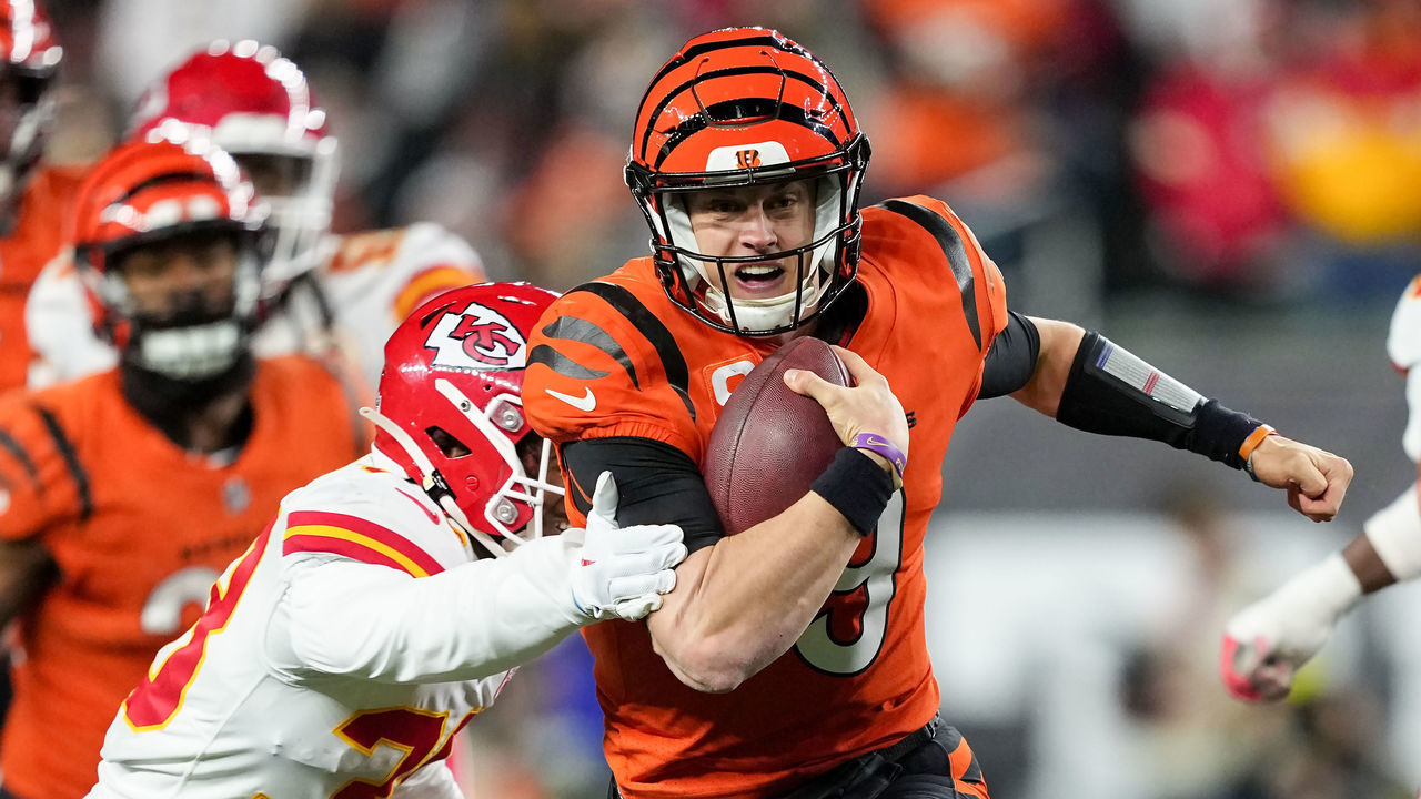 CINCINNATI, OHIO - DECEMBER 04: Joe Burrow #9 of the Cincinnati Bengals runs with the ball while being chased by L'Jarius Sneed #38 of the Kansas City Chiefs in the third quarter at Paycor Stadium on December 04, 2022 in Cincinnati, Ohio.