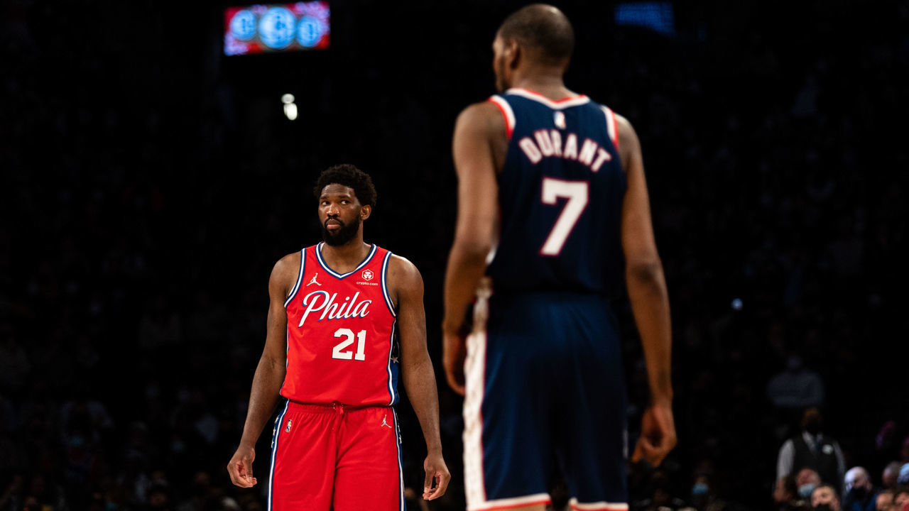 NEW YORK, NEW YORK - DECEMBER 30: Joel Embiid #21 of the Philadelphia 76ers looks towards Kevin Durant #7 of the Brooklyn Nets during the fourth quarter at Barclays Center on December 30, 2021 in New York City.