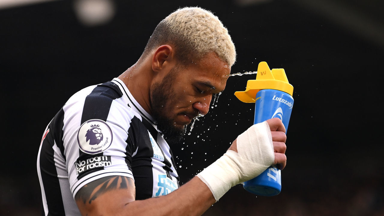 NEWCASTLE UPON TYNE, ENGLAND - JANUARY 15: Joelinton of Newcastle United sprays water during the Premier League match between Newcastle United and Fulham FC at St. James Park on January 15, 2023 in Newcastle upon Tyne, England.