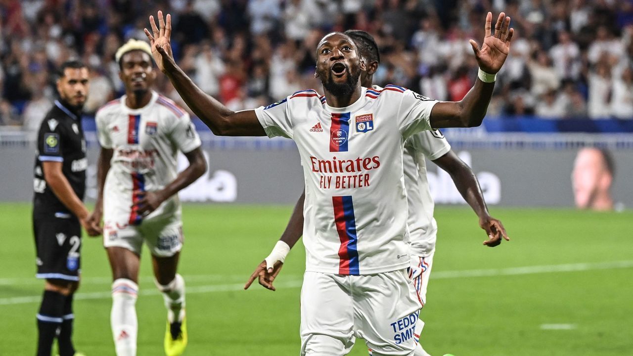 Lyon's Cameroonian forward Karl Toko Ekambi (C) celebrates after scoring his team's second goal during the French L1 football match between Olympique Lyonnais (OL) and AJ Auxerre at The Groupama Stadium in Decines-Charpieu, central-eastern France on August 31, 2022.