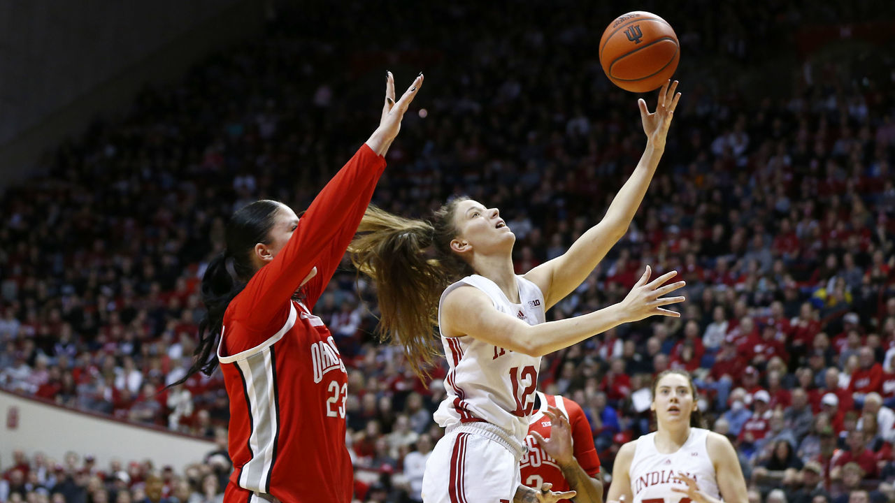 BLOOMINGTON, IN - JANUARY 26: Indiana Hoosiers guard Yarden Garzon (12) drives past Ohio State Buckeyes forward Rebeka Mikulasikova (23) and goes up with her shot from the lane during a womens college basketball game between the Ohio State Buckeyes and the Indiana Hoosiers on January 26, 2023 at Simon Skjodt Assembly Hall, in Bloomington, IN.