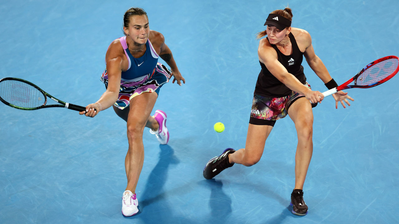 FILE PHOTO (EDITORS NOTE: COMPOSITE OF IMAGES - Image numbers 1459600772, 1458945221 - GRADIENT ADDED) In this composite image a comparison has been made between Aryna Sabalenka (L) and Elena Rybakina. They will meet in the Australian Open Women’s Final on January 28,2023 at Melbourne Park in Melbourne, Australia. ***LEFT IMAGE*** MELBOURNE, AUSTRALIA - JANUARY 26: Aryna Sabalenka plays a forehand in the Semifinal singles match against Magda Linette of Poland during day 11 of the 2023 Australian Open at Melbourne Park on January 26, 2023 in Melbourne, Australia.