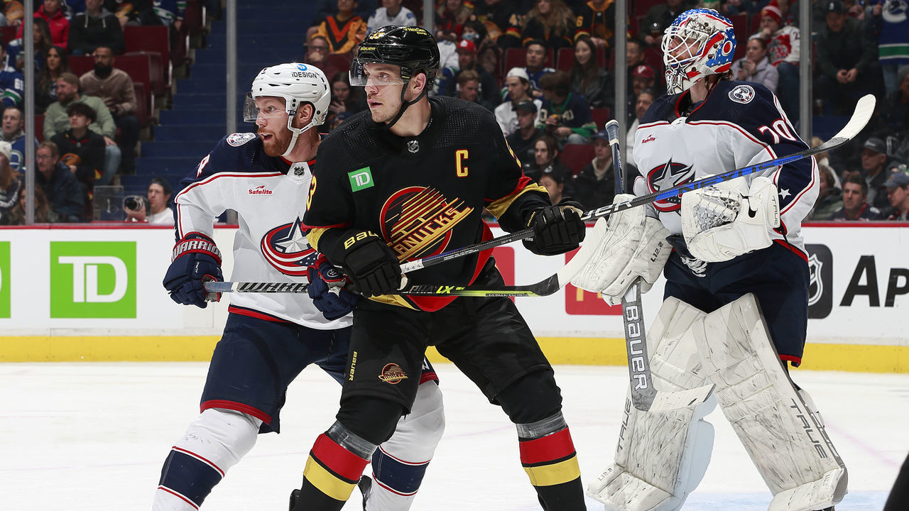 VANCOUVER, CANADA - JANUARY 27: Bo Horvat #53 of the Vancouver Canucks and Vladislav Gavrikov #4 of the Columbus Blue Jackets look up the ice awaiting the puck during the second period of their NHL game at Rogers Arena January 27, 2023 in Vancouver, British Columbia, Canada.