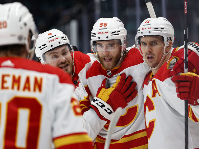 SEATTLE, WASHINGTON - JANUARY 27: Noah Hanifin #55 of the Calgary Flames celebrates his goal against the Seattle Kraken during the third period at Climate Pledge Arena on January 27, 2023 in Seattle, Washington.