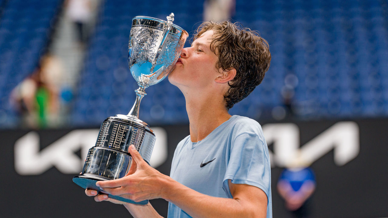 MELBOURNE, AUSTRALIA - JANUARY 28: Alexander Blockx of Belgium poses with the championship trophy after winning the Junior Boys’ Singles Final against Learner Tien of the United States during day 13 of the 2023 Australian Open at Melbourne Park on January 28, 2023 in Melbourne, Australia