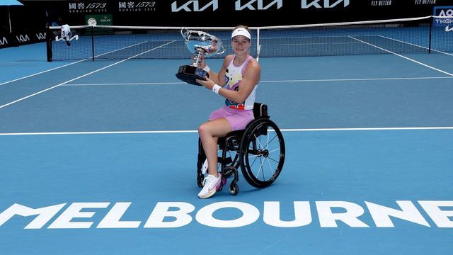 Netherlands' Diede De Groot poses with the winning trophy after defeating Japan's Yui Kamiji in the women's wheelchair singles final match on day thirteen of the Australian Open tennis tournament in Melbourne on January 28, 2023. - -- IMAGE RESTRICTED TO EDITORIAL USE - STRICTLY NO COMMERCIAL USE --