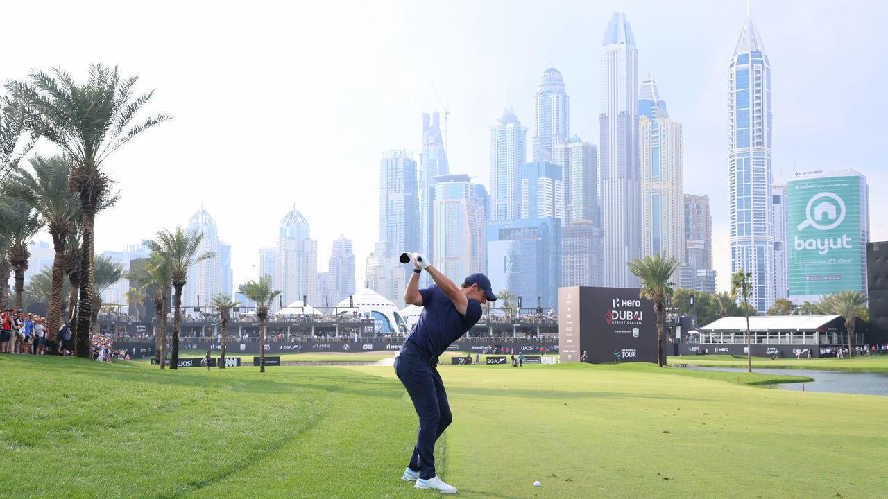 DUBAI, UNITED ARAB EMIRATES - JANUARY 28: Rory McIlroy of Northern Ireland plays his second shot on the 18th hole during the continuation of Round Two on Day Three of the Hero Dubai Desert Classic at Emirates Golf Club on January 28, 2023 in Dubai, United Arab Emirates.