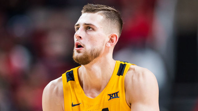 LUBBOCK, TEXAS - JANUARY 25: Guard Erik Stevenson #10 of the West Virginia Mountaineers shoots the ball during the second half of the college basketball game against the Texas Tech Red Raiders at United Supermarkets Arena on January 25, 2023 in Lubbock, Texas.