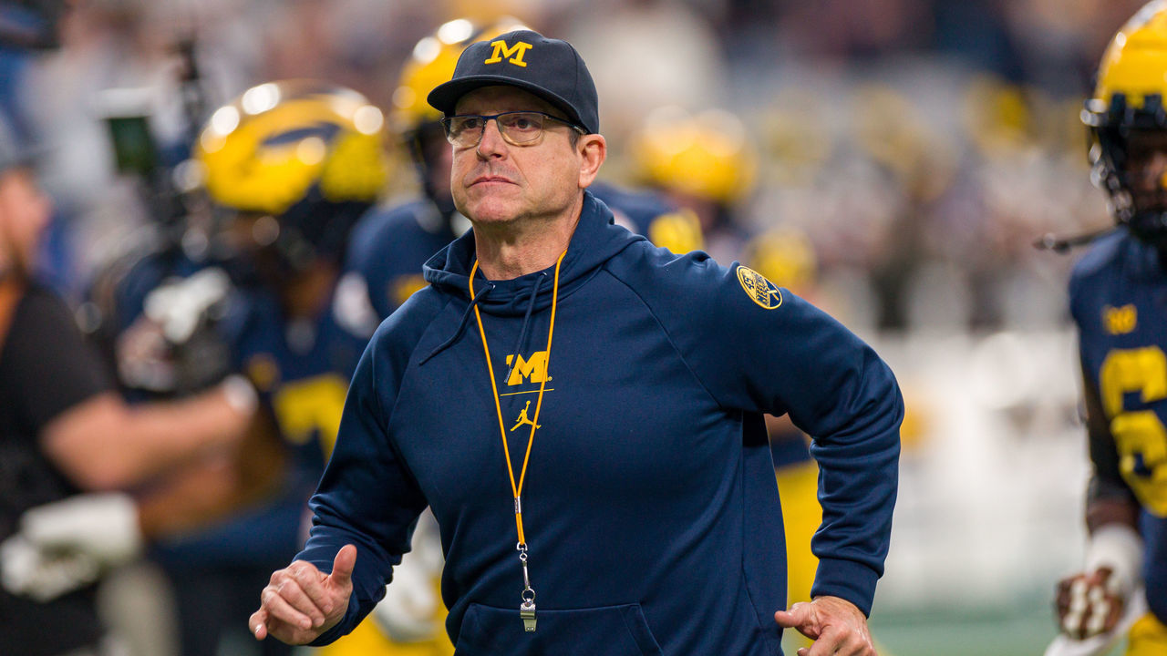 GLENDALE, AZ - DECEMBER 31: Michigan Wolverines head coach Jim Harbaugh runs onto the field before the Vrbo Fiesta Bowl between the Michigan Wolverines and the TCU Horned Frogs on Saturday, December 31st, 2022 at State Farm Stadium in Glendale, AZ