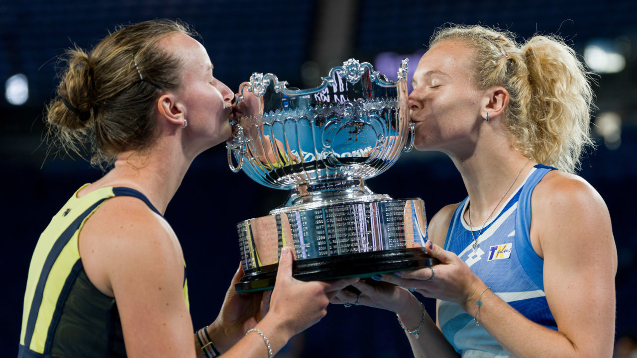 MELBOURNE, AUSTRALIA - JANUARY 29: Barbora Krejcikova and Katerina Siniakova of the Czech Republic pose with the championship trophy after winning championship point in the Women's Doubles Final against Shuko Aoyama and Ena Shibahara of Japan during day 14 of the 2023 Australian Open at Melbourne Park on January 29, 2023 in Melbourne, Australia.