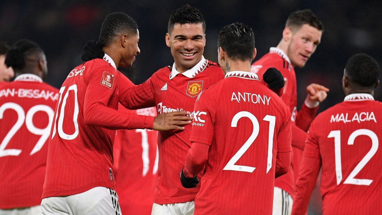 Manchester United's Brazilian midfielder Casemiro (C) celebrates with teammates after scoring their second goal during the English FA Cup fourth round football match between Manchester United and Reading at Old Trafford in Manchester, north west England, on January 28, 2023. - RESTRICTED TO EDITORIAL USE. No use with unauthorized audio, video, data, fixture lists, club/league logos or 'live' services. Online in-match use limited to 120 images. An additional 40 images may be used in extra time. No video emulation. Social media in-match use limited to 120 images. An additional 40 images may be used in extra time. No use in betting publications, games or single club/league/player publications.