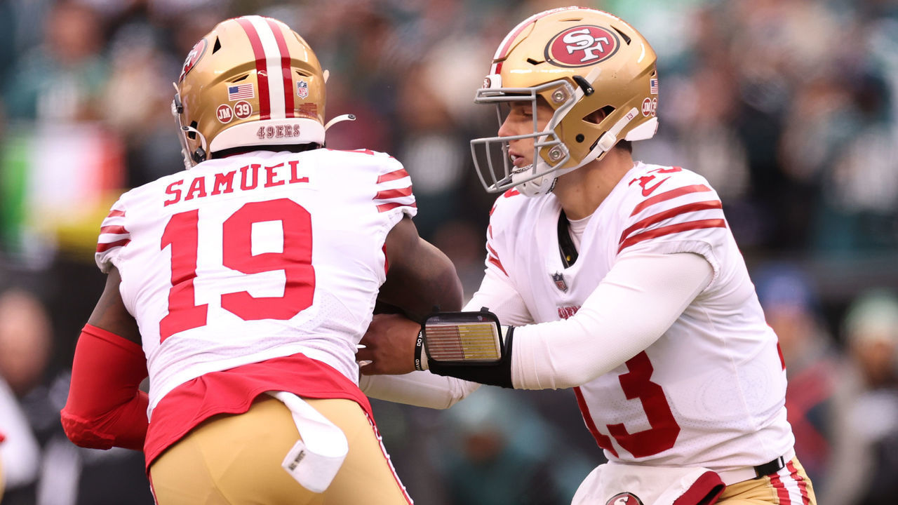 PHILADELPHIA, PENNSYLVANIA - JANUARY 29: Brock Purdy #13 of the San Francisco 49ers hands the ball off to Deebo Samuel #19 against the Philadelphia Eagles during the first quarter in the NFC Championship Game at Lincoln Financial Field on January 29, 2023 in Philadelphia, Pennsylvania.