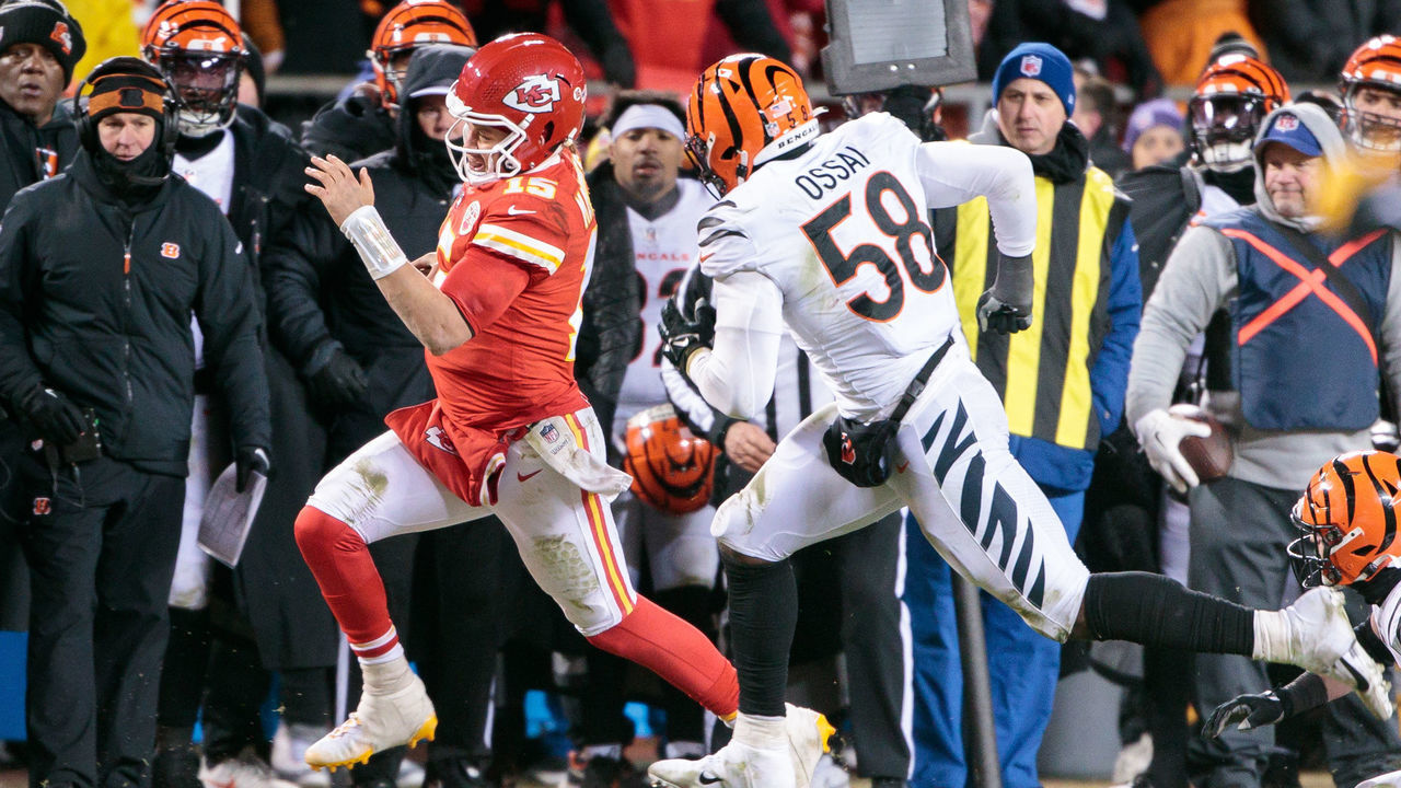 KANSAS CITY, MO - JANUARY 29: Kansas City Chiefs quarterback Patrick Mahomes (15) heads out of bounds in front of Cincinnati Bengals defensive end Joseph Ossai (58) during the last second of the game on January 29th, 2023 at Arrowhead Stadium in Kansas City, Missouri.