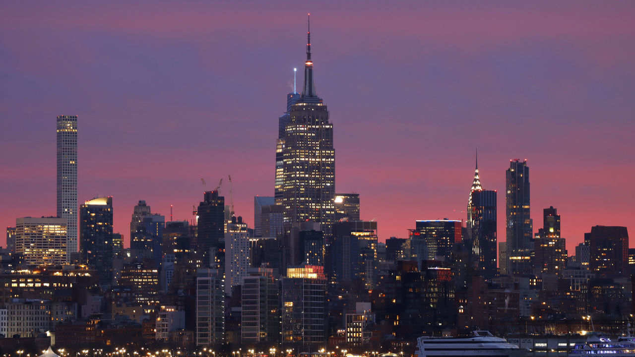 JERSEY CITY, NJ - JANUARY 19: The sun rises behind the skyline of midtown Manhattan and the Empire State Building in New York City on January 19, 2023, as seen from Jersey City, New Jersey.