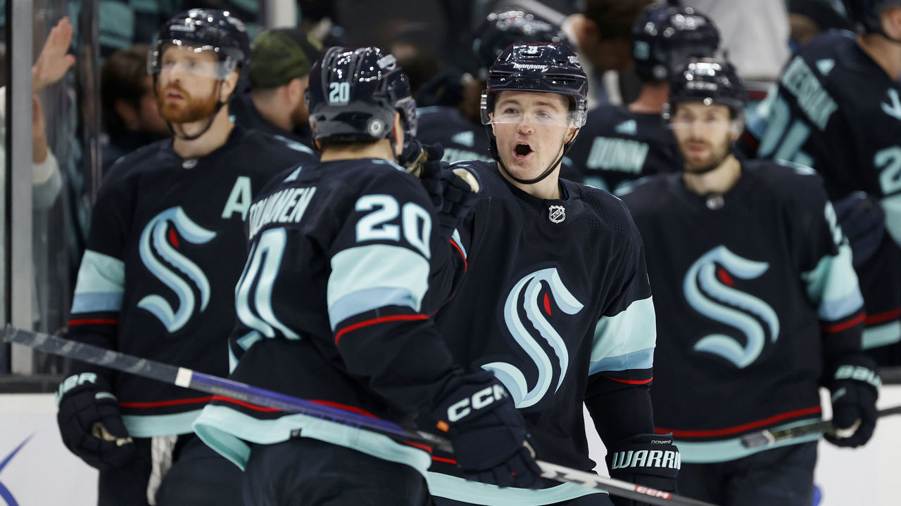 SEATTLE, WASHINGTON - JANUARY 27: Eeli Tolvanen #20 and Ryan Donato #9 of the Seattle Kraken celebrate a goal during the third period against the Calgary Flames at Climate Pledge Arena on January 27, 2023 in Seattle, Washington.