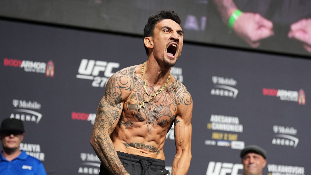 LAS VEGAS, NEVADA - JULY 01: Max Holloway poses on the scale during the UFC 276 ceremonial weigh-in at T-Mobile Arena on July 01, 2022 in Las Vegas, Nevada.