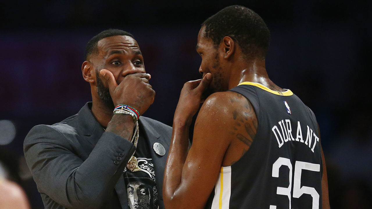 LOS ANGELES, CALIFORNIA - APRIL 04: LeBron James #23 of the Los Angeles Lakers speaks to Kevin Durant #35 of the Golden State Warriors during a timeout in the first half at Staples Center on April 04, 2019 in Los Angeles, California.
