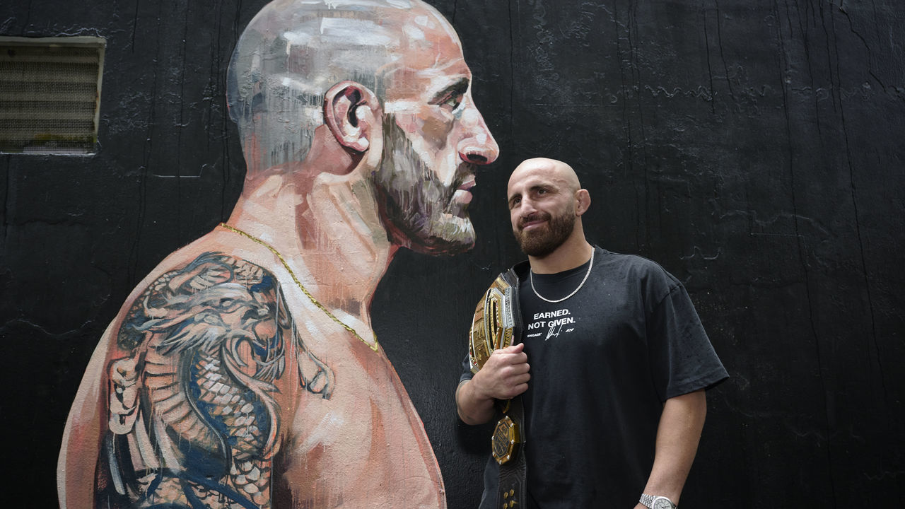 SYDNEY, AUSTRALIA - JANUARY 22: UFC featherweight champion, Alex Volkanovski poses for a photo in front of a mural during a UFC284 Media Opportunity on January 22, 2023 in Sydney, Australia.