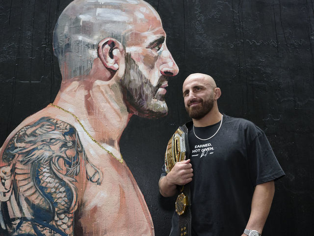 SYDNEY, AUSTRALIA - JANUARY 22: UFC featherweight champion, Alex Volkanovski poses for a photo in front of a mural during a UFC284 Media Opportunity on January 22, 2023 in Sydney, Australia.