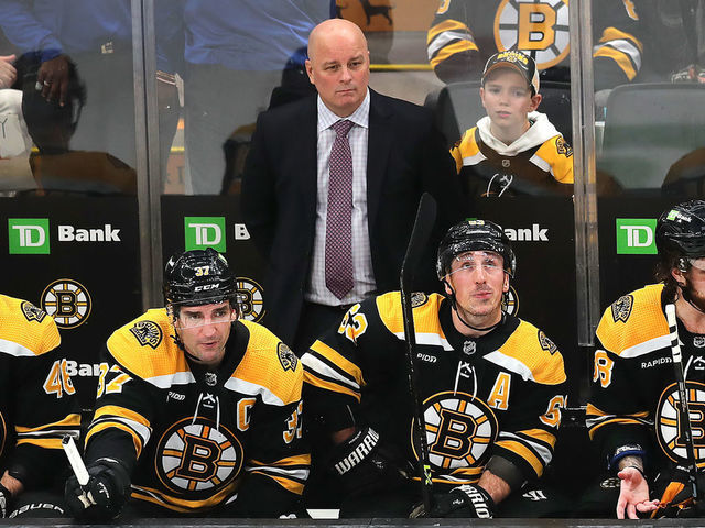 Boston, MA - January 12: Boston Bruins head coach Jim Montgomery and from left to right, David Krejci, Patrice Bergeron, Brad Marchand and David Pastrnak, look glum on the bench. The Bruins lost to the Seattle Kraken, 3-0.