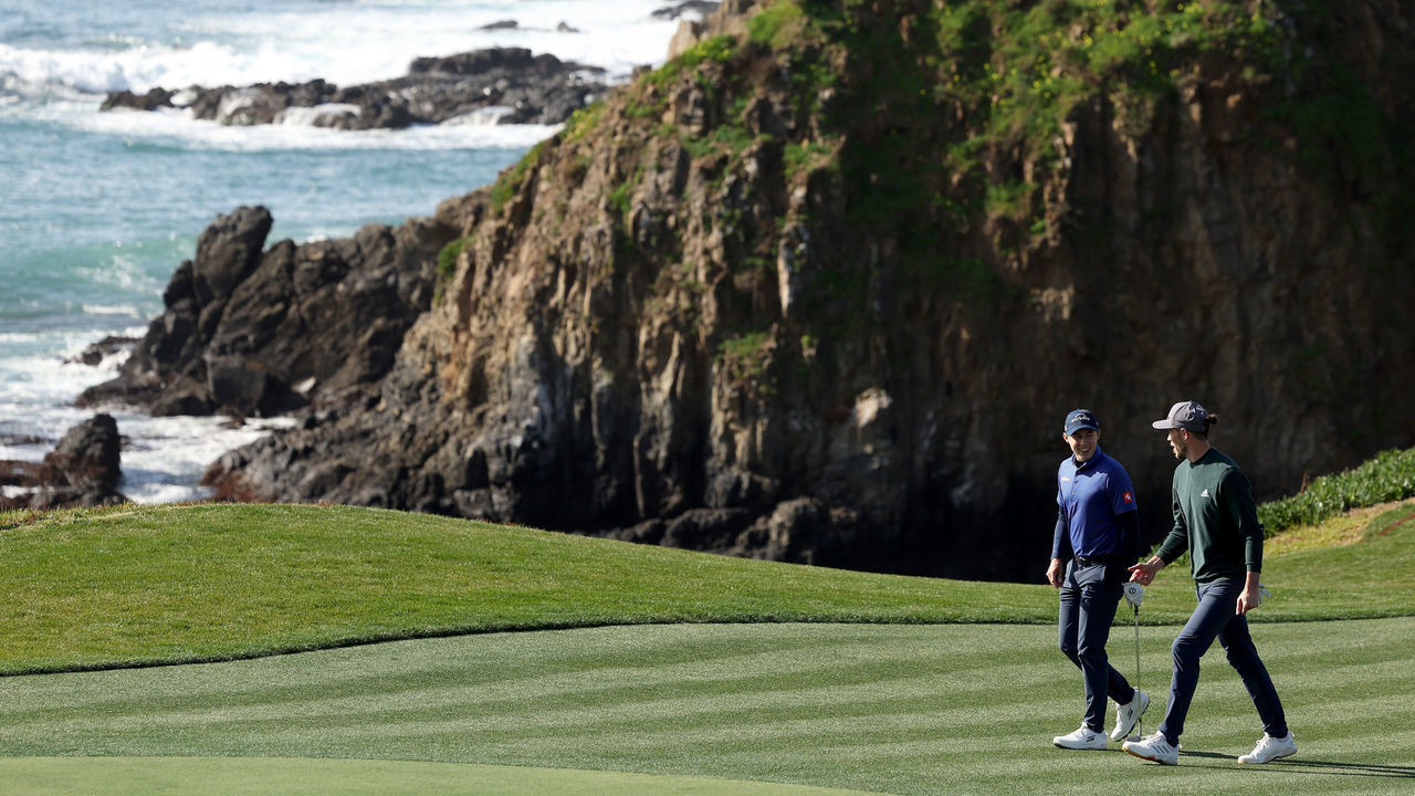 PEBBLE BEACH, CALIFORNIA - FEBRUARY 01: Matthew Fitzpatrick of England walks up the eighth fairway with retired professional footballer Gareth Bale of Wales prior to the AT&T Pebble Beach Pro-Am at Pebble Beach Golf Links on February 01, 2023 in Pebble Beach, California.