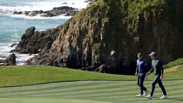 PEBBLE BEACH, CALIFORNIA - FEBRUARY 01: Matthew Fitzpatrick of England walks up the eighth fairway with retired professional footballer Gareth Bale of Wales prior to the AT&T Pebble Beach Pro-Am at Pebble Beach Golf Links on February 01, 2023 in Pebble Beach, California.