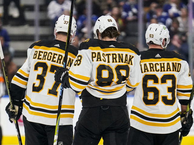 TORONTO, ON - FEBRUARY 1: Patrice Bergeron #37, David Pastrnak #88 and Brad Marchand #63 of the Boston Bruins look on against the Toronto Maple Leafs during the first period at the Scotiabank Arena on February 1, 2023 in Toronto, Ontario, Canada.