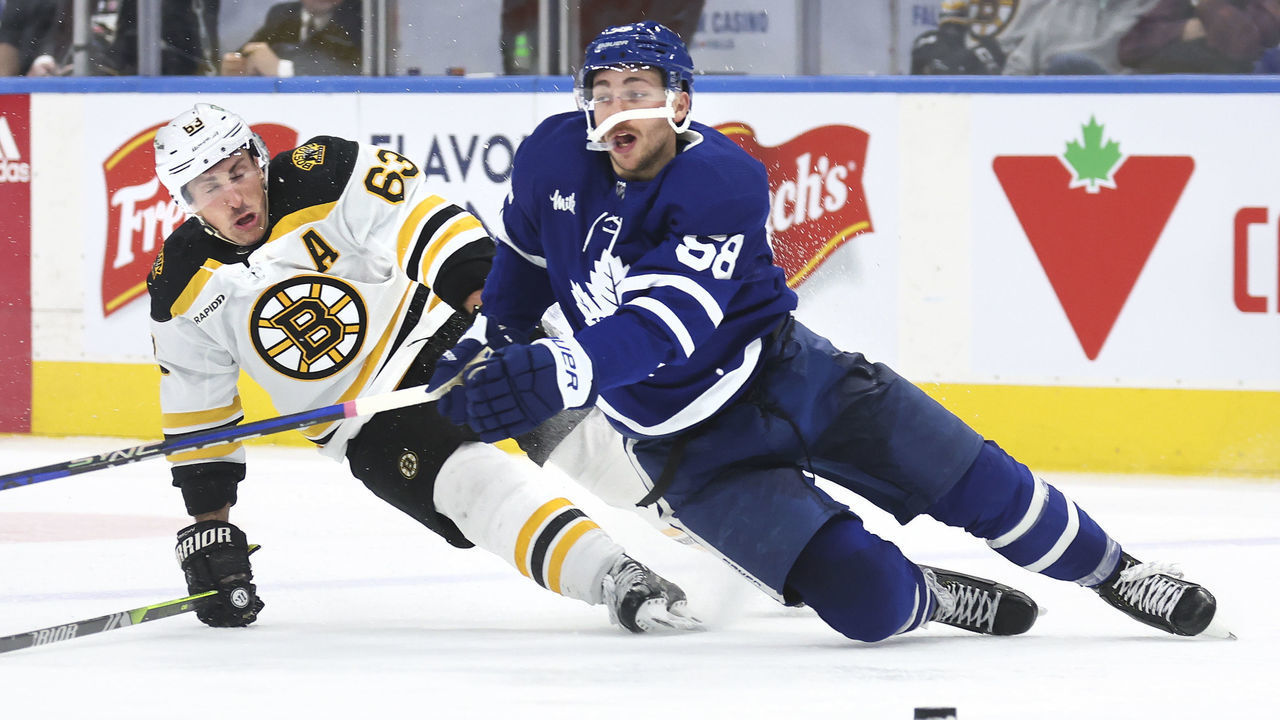 TORONTO, ON - February 1 In third period action, the Leafs Michael Bunting and Brad Marchand go down in the neutral zone. The Toronto Maple Leafs lost to the Boston Bruins 5-2 in NHL hockey action at the Scotiabank Arena in Toronto. February 1 2023 (Richard Lautens/Toronto Star via Getty Images)