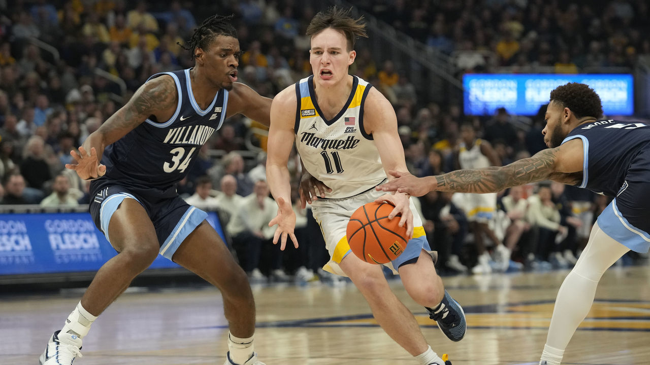 MILWAUKEE, WISCONSIN - FEBRUARY 01: Tyler Kolek #11 of the Marquette Golden Eagles dribbles the ball against Brandon Slater #34 of the Villanova Wildcats during the first half at Fiserv Forum on February 01, 2023 in Milwaukee, Wisconsin.