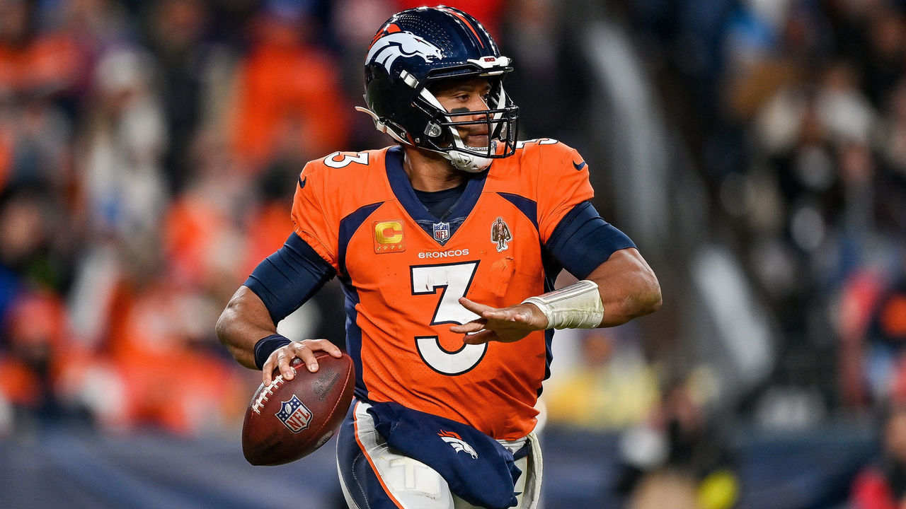 DENVER, CO - JANUARY 8: Denver Broncos quarterback Russell Wilson (3) rolls out of the pocket during a game between the Los Angeles Chargers and the Denver Broncos at Empower Field at Mile High on January 8, 2023 in Denver, Colorado.